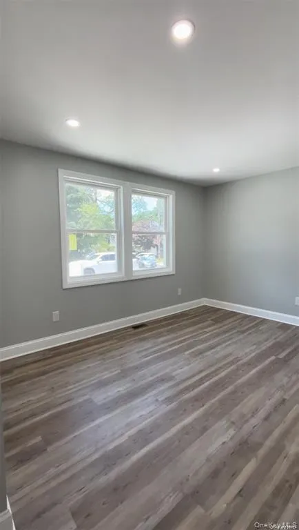 Unfurnished room featuring dark wood-type flooring and recessed lighting Unfurnished room featuring dark wood-type flooring and recessed lighting