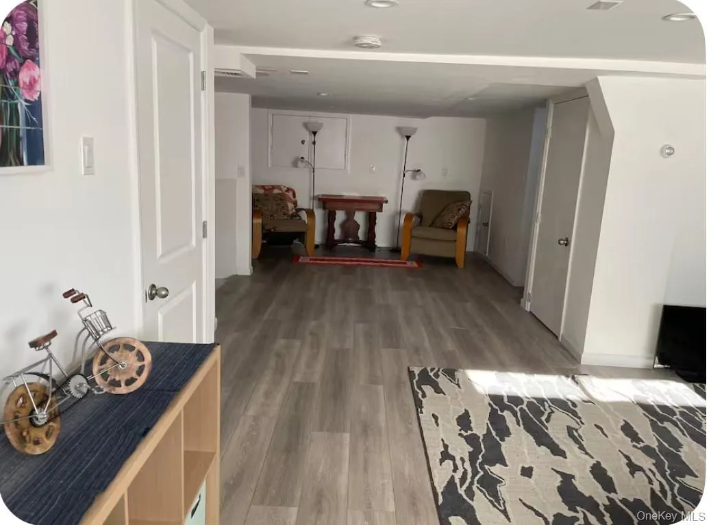 Hall with light wood finished floors and recessed lighting Hall with light wood finished floors and recessed lighting