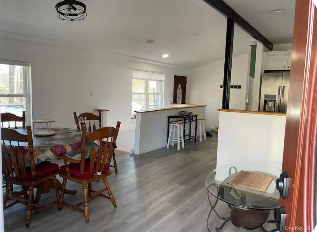 Dining area with wood finished floors and recessed lighting Dining area with wood finished floors and recessed lighting