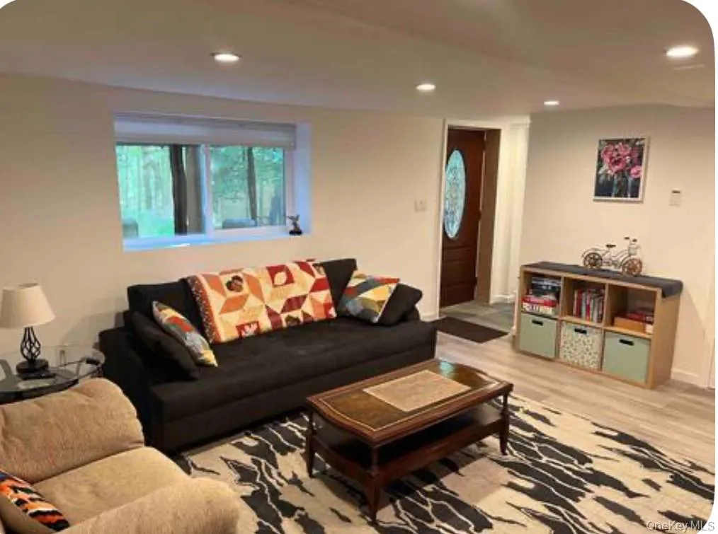 Living room with recessed lighting and light wood finished floors Living room with recessed lighting and light wood finished floors