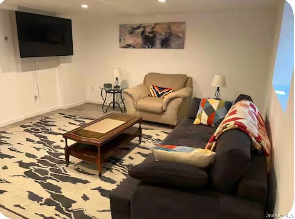 Living room featuring baseboards and recessed lighting Living room featuring baseboards and recessed lighting