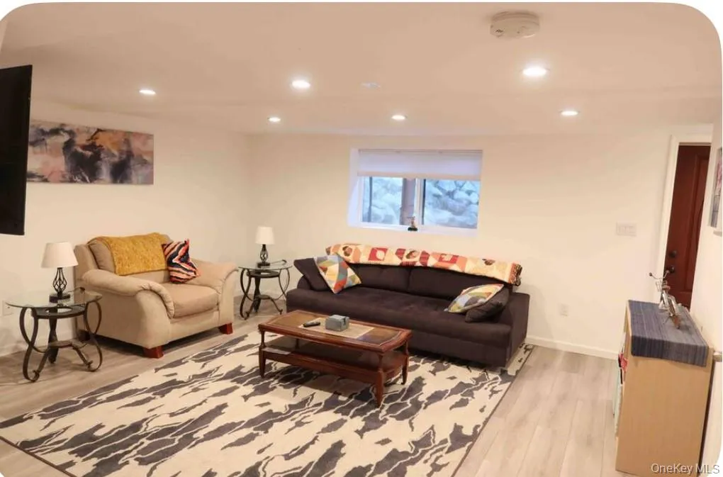 Living area featuring recessed lighting and light wood-type flooring Living area featuring recessed lighting and light wood-type flooring