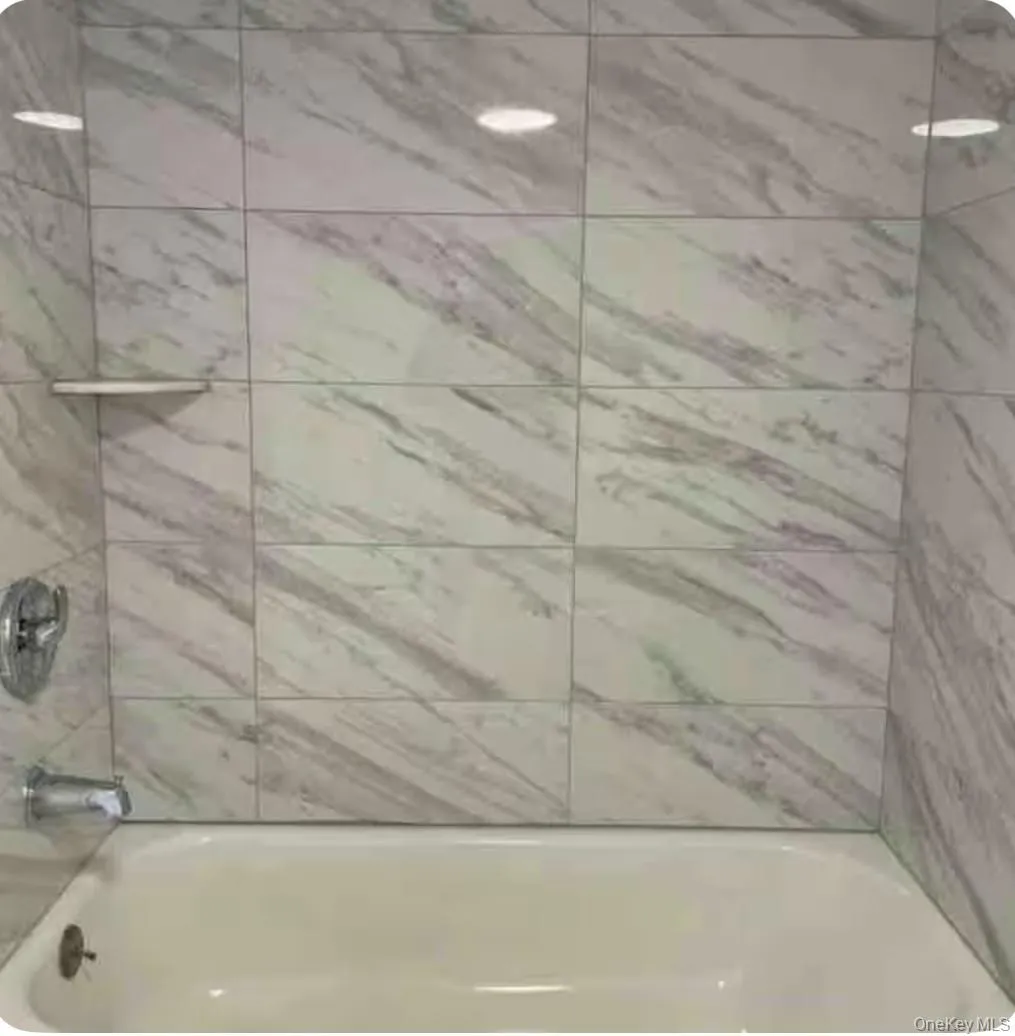 Bathroom featuring shower / bath combination Bathroom featuring shower / bath combination