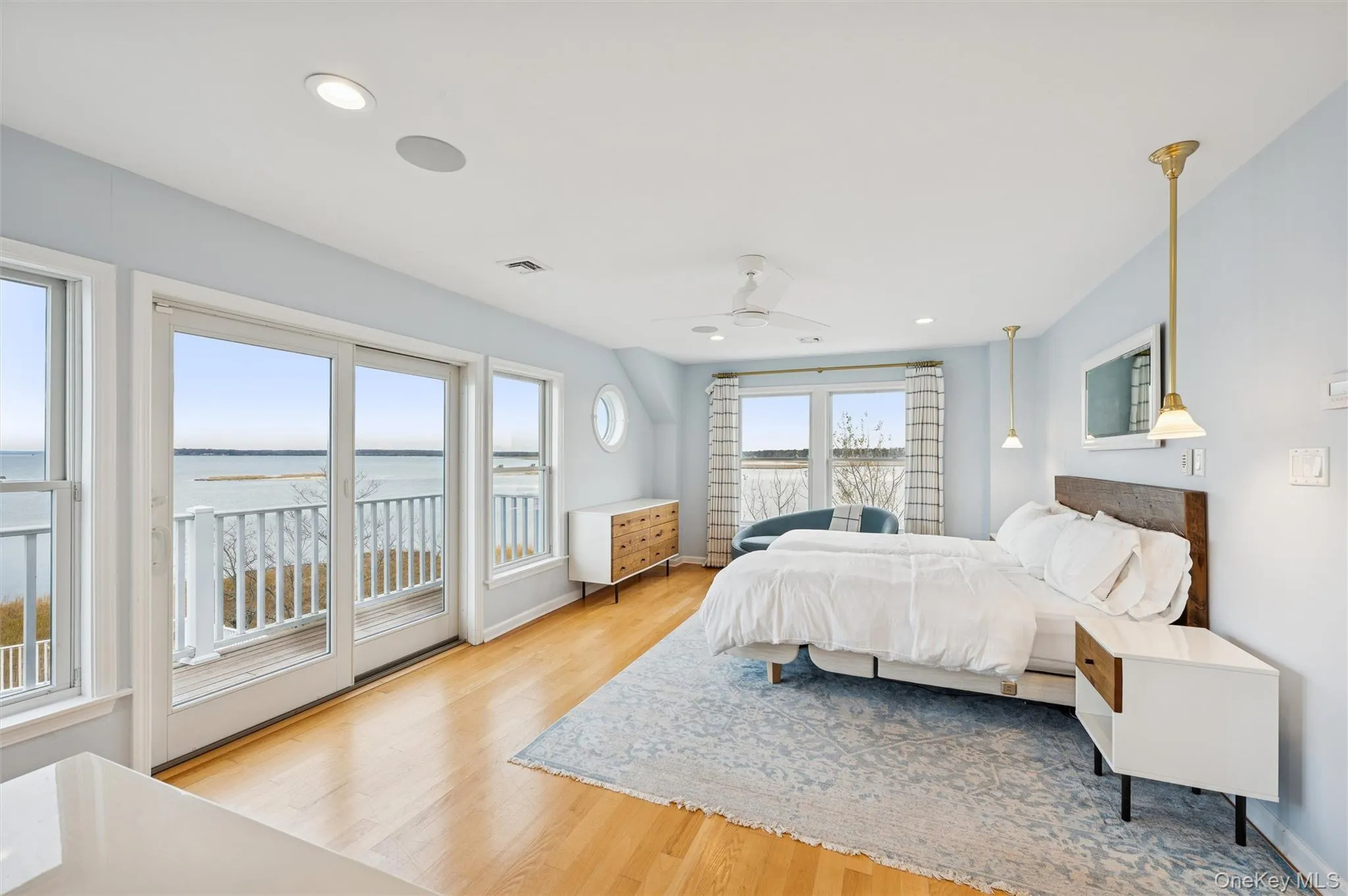 Bedroom with a water view, light wood finished floors, access to outside, recessed lighting, and ceiling fan Bedroom with a water view, light wood finished floors, access to outside, recessed lighting, and ceiling fan