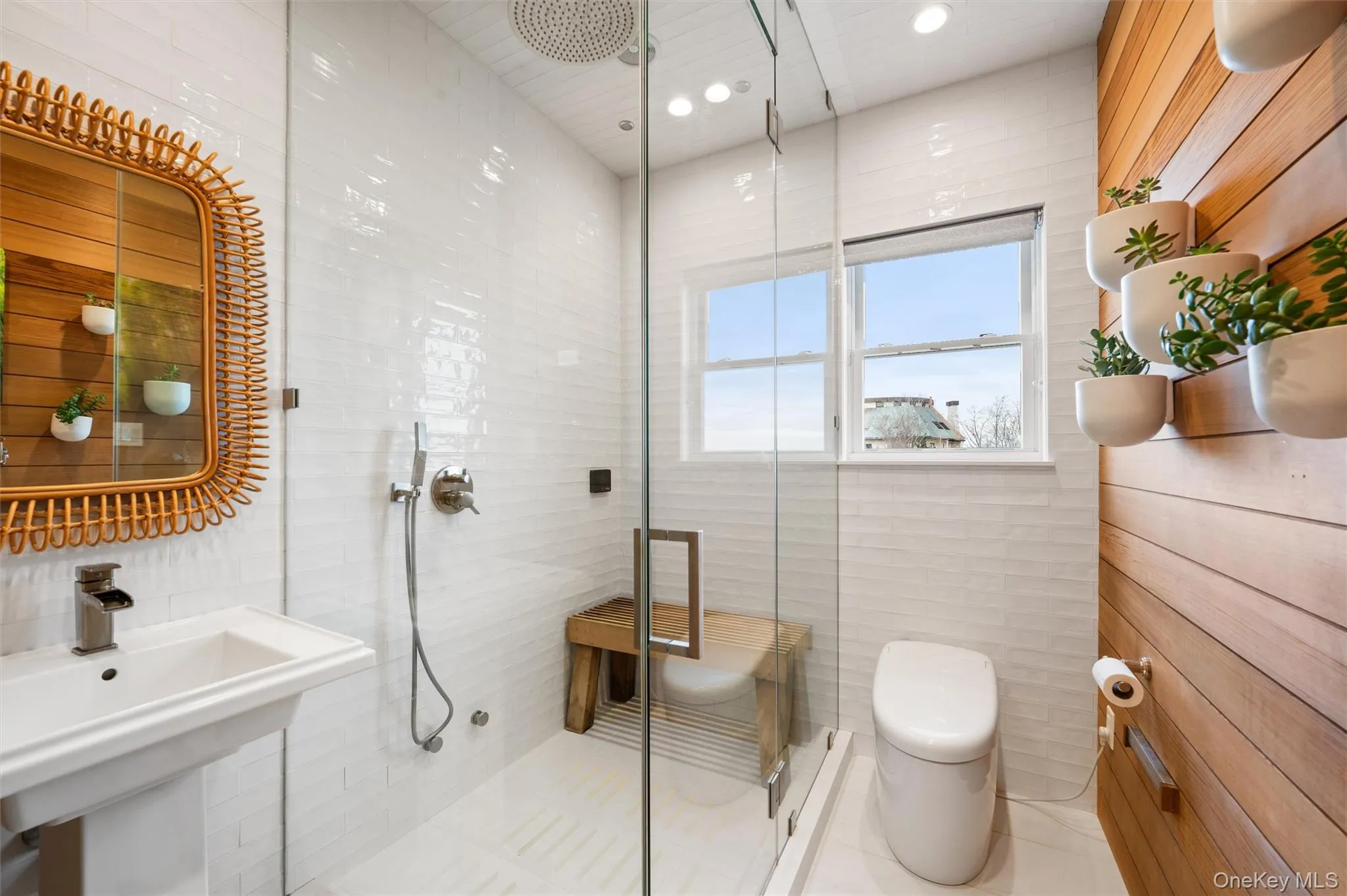 Full bath featuring a stall shower, recessed lighting, tile walls, and tile patterned floors Full bath featuring a stall shower, recessed lighting, tile walls, and tile patterned floors
