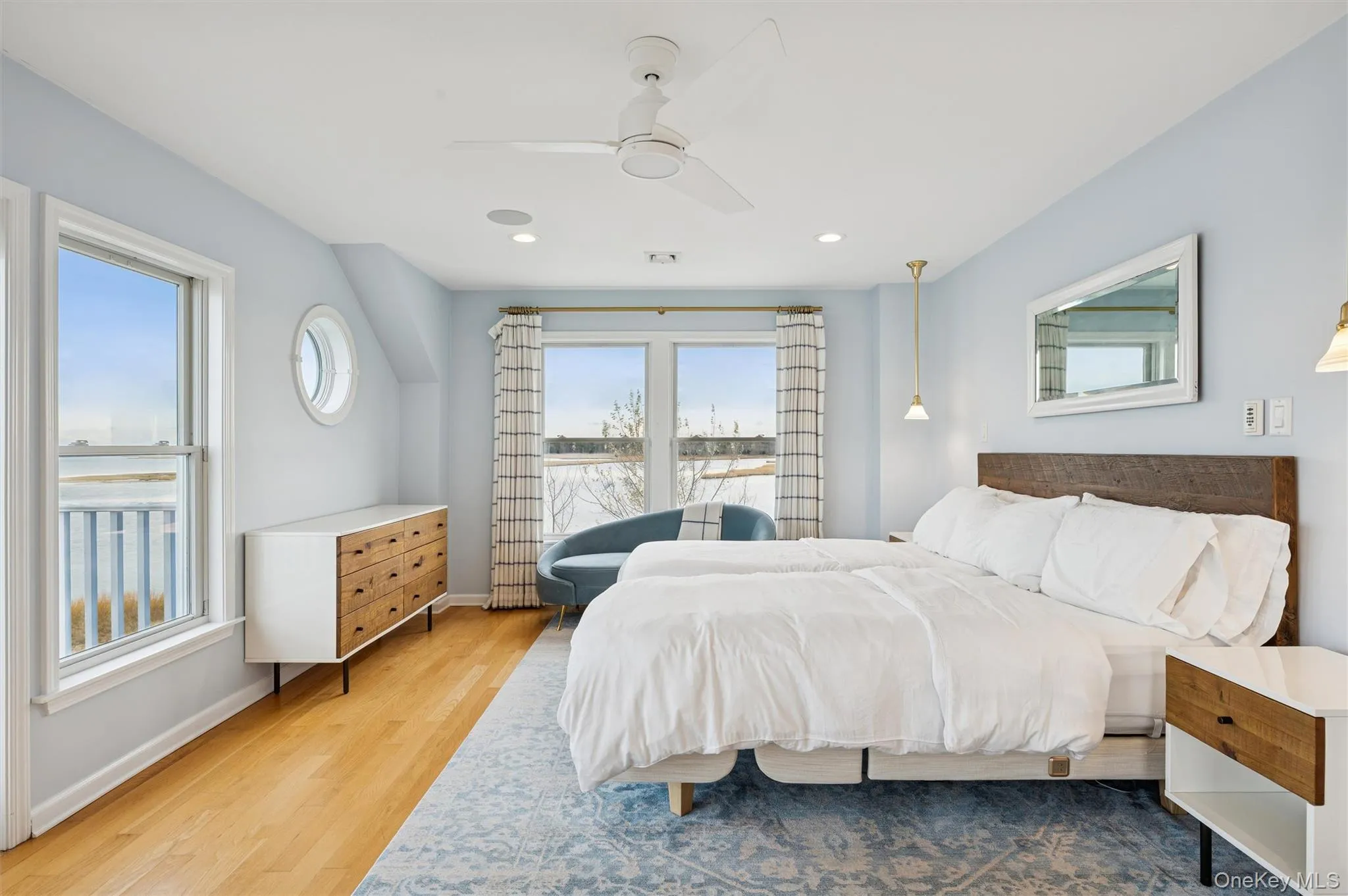 Bedroom featuring light wood finished floors and ceiling fan Bedroom featuring light wood finished floors and ceiling fan