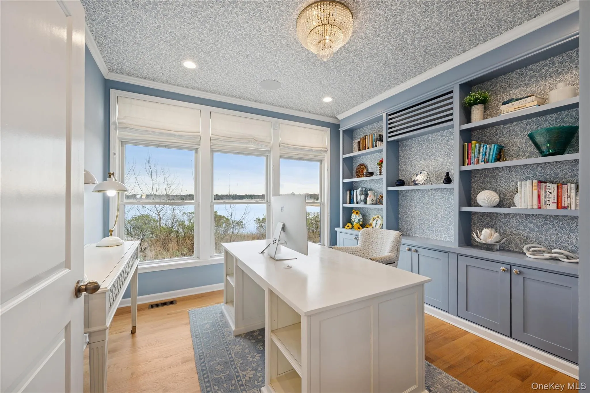 Office area featuring light wood-style flooring, a water view, crown molding, a textured ceiling, and recessed lighting Office area featuring light wood-style flooring, a water view, crown molding, a textured ceiling, and recessed lighting