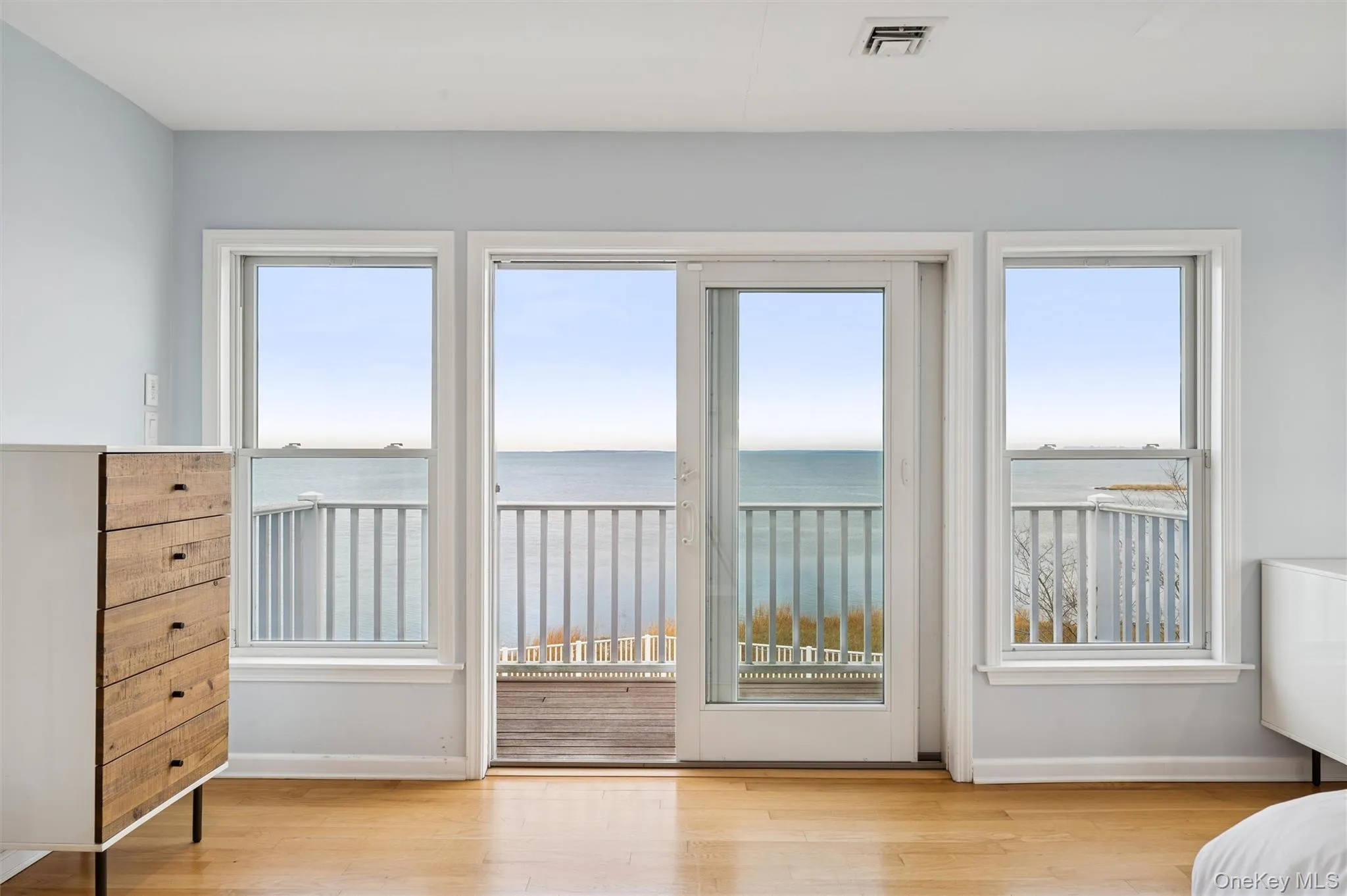 Unfurnished bedroom with a water view, access to exterior, and light wood-type flooring Unfurnished bedroom with a water view, access to exterior, and light wood-type flooring