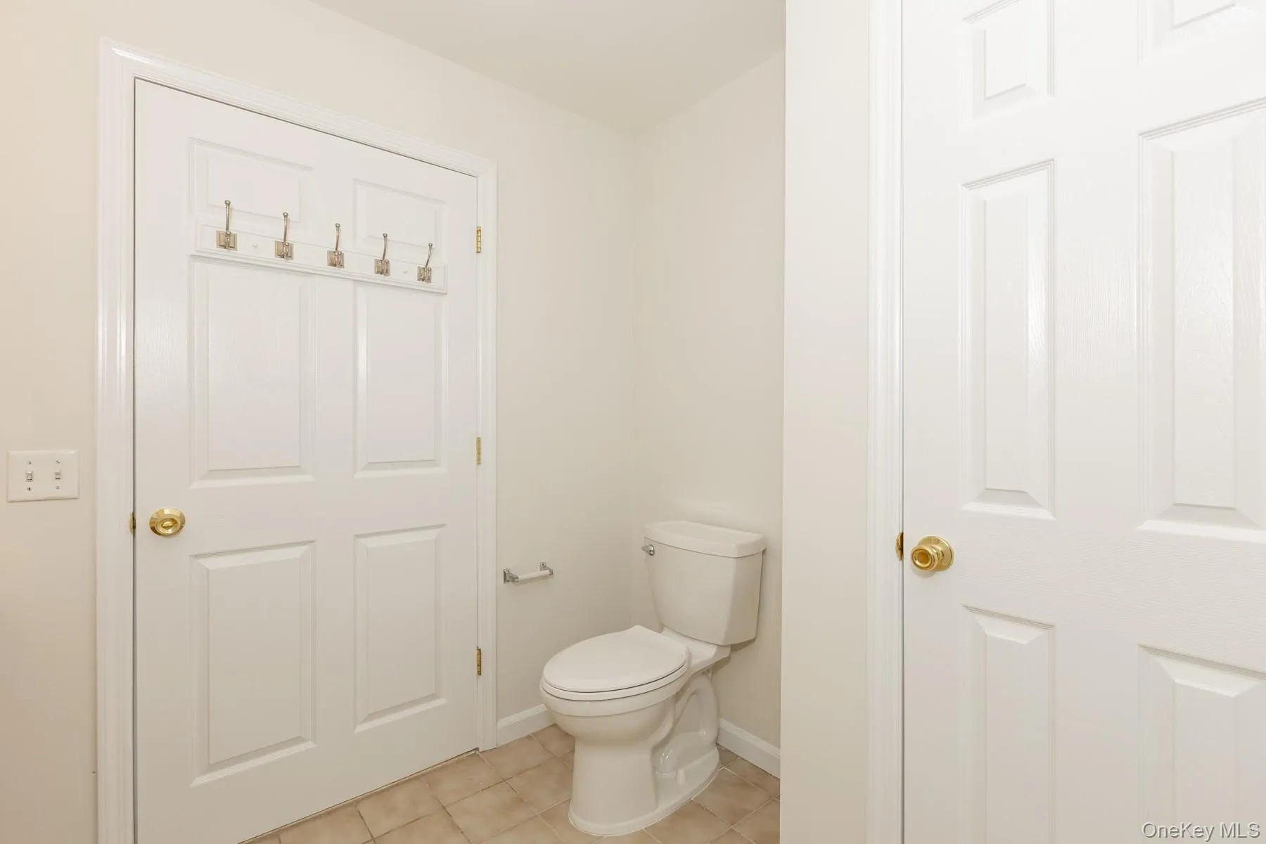Bathroom with light tile patterned floors and toilet Bathroom with light tile patterned floors and toilet
