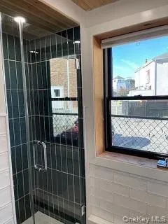 View of shower with stylish tile and glass shower door. View of shower with stylish tile and glass shower door.