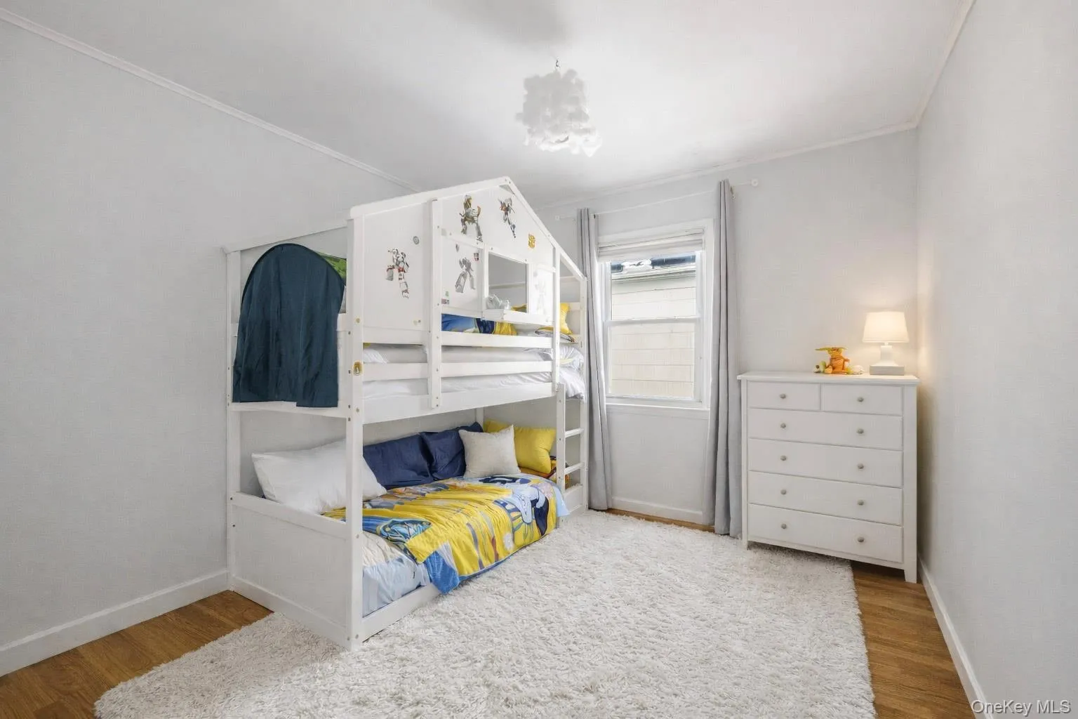 Bedroom with light wood finished floors and crown molding Bedroom with light wood finished floors and crown molding