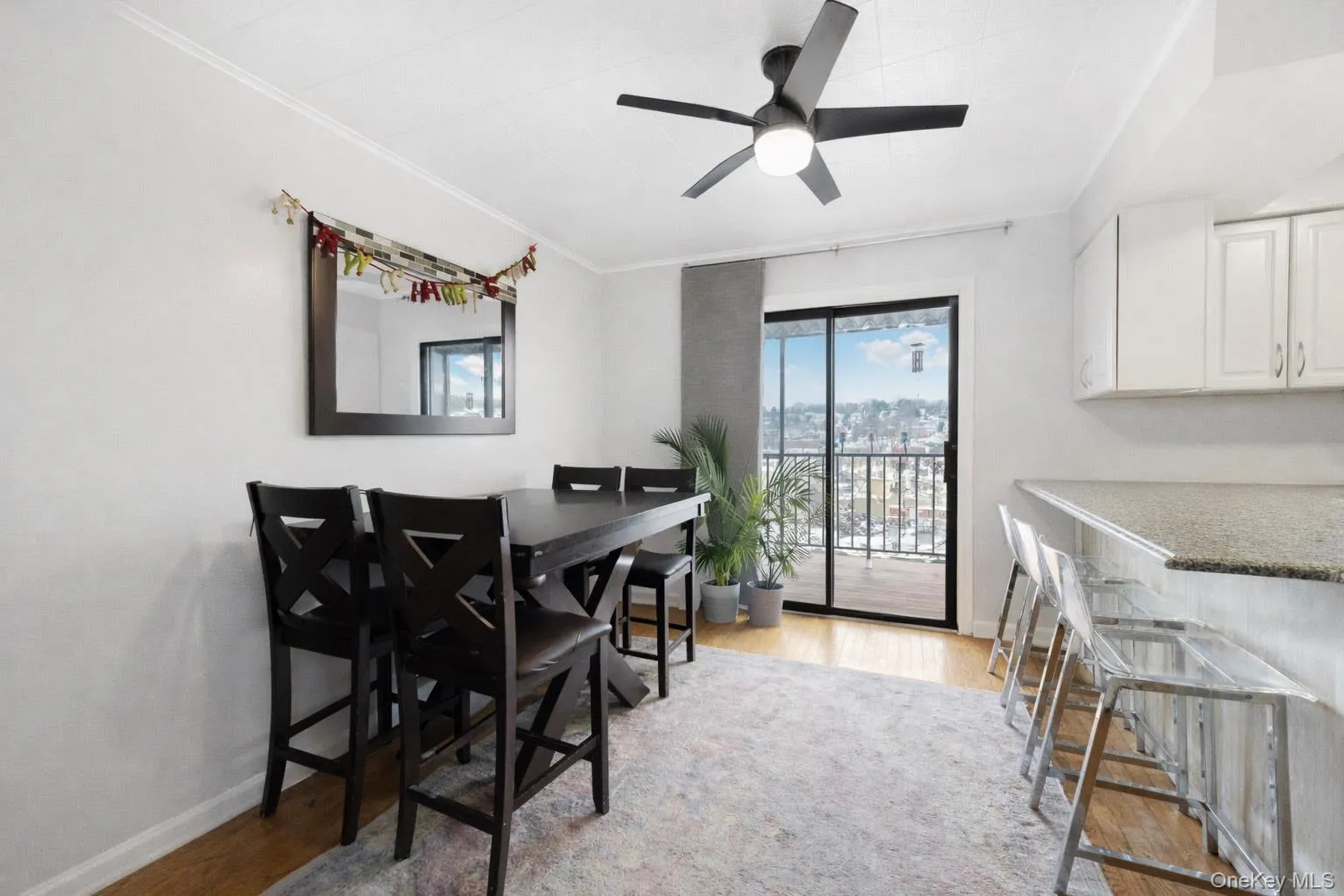 Dining area with crown molding, light wood finished floors, and a ceiling fan Dining area with crown molding, light wood finished floors, and a ceiling fan