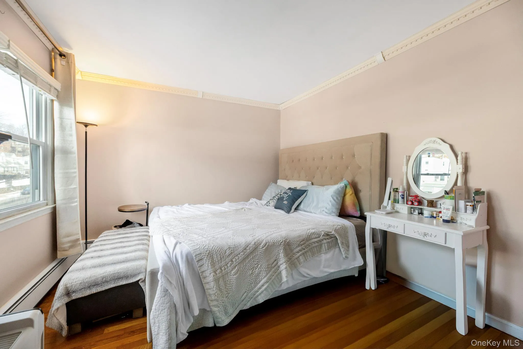 Bedroom with crown molding and dark wood-style floors Bedroom with crown molding and dark wood-style floors