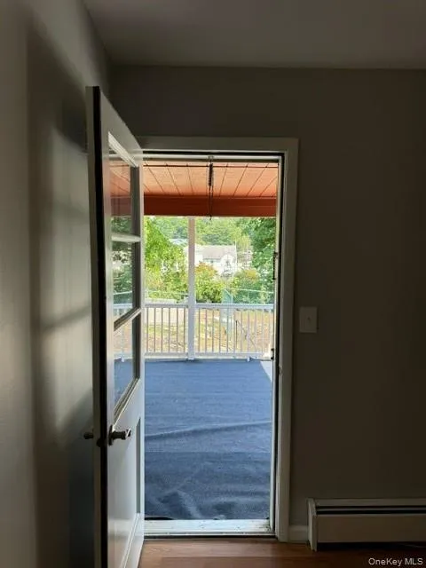 Entryway featuring hardwood / wood-style floors and baseboard heating Entryway featuring hardwood / wood-style floors and baseboard heating
