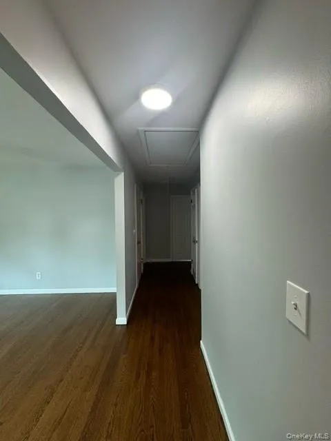 Hall featuring dark hardwood / wood-style flooring Hall featuring dark hardwood / wood-style flooring