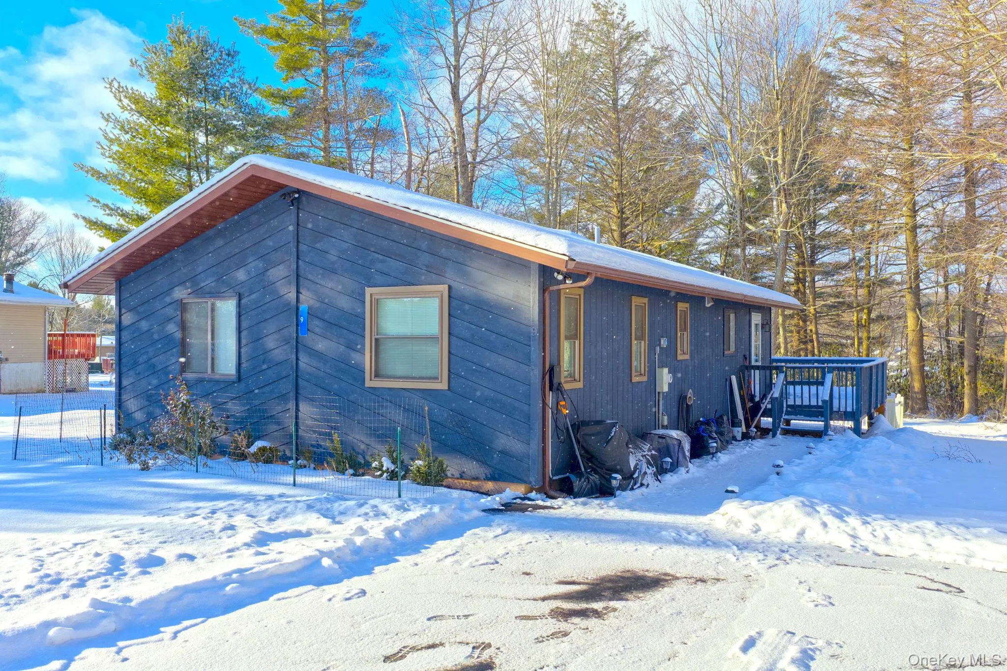 View of snowy exterior with a deck View of snowy exterior with a deck