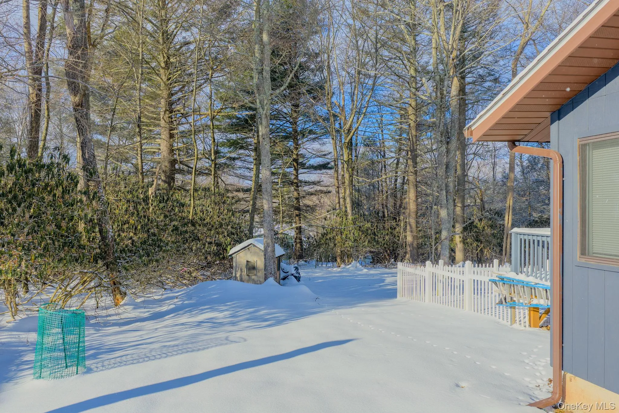 Yard covered in snow with an outdoor structure Yard covered in snow with an outdoor structure