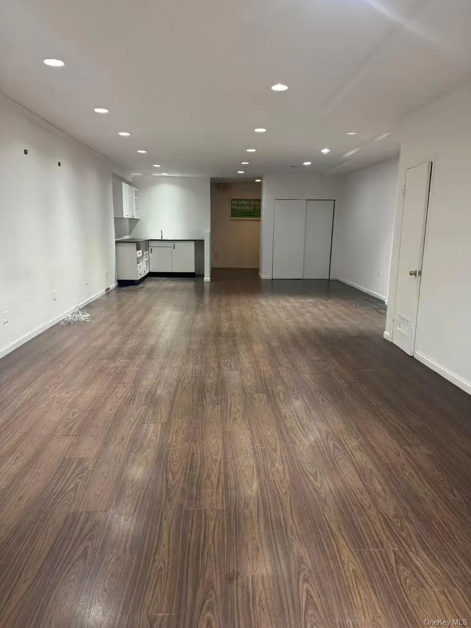 Unfurnished room with recessed lighting and dark wood-style flooring Unfurnished room with recessed lighting and dark wood-style flooring