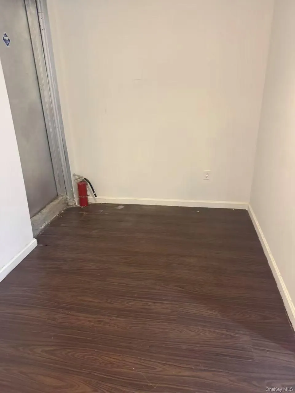 room with baseboards and dark wood-style floors room with baseboards and dark wood-style floors