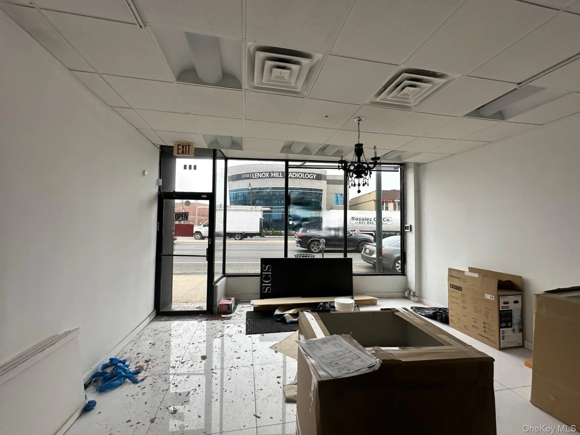 Office area with a drop ceiling and a wall of windows Office area with a drop ceiling and a wall of windows