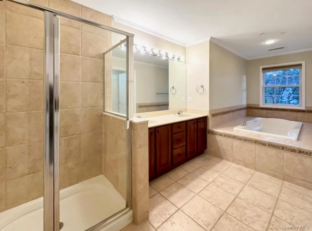 The en-suite primary bathroom includes a jacuzzi, separate shower, and water closet. The en-suite primary bathroom includes a jacuzzi, separate shower, and water closet.