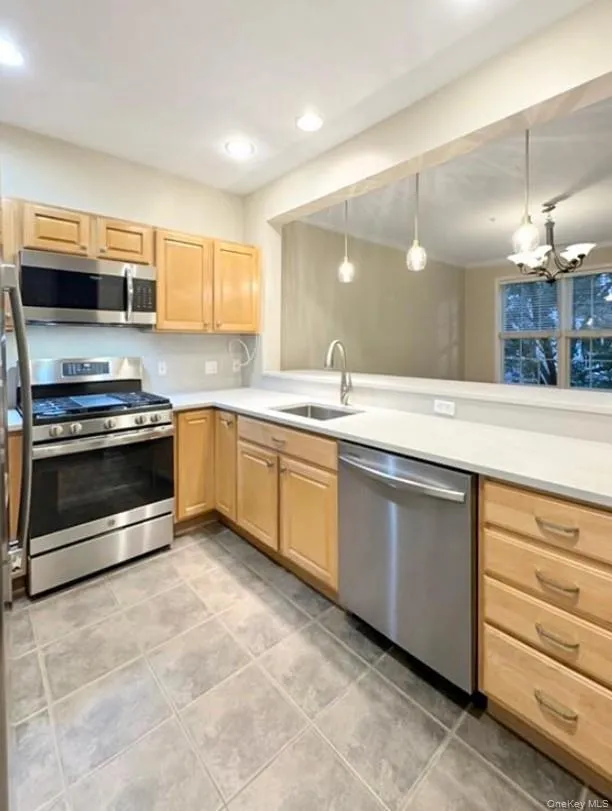 The kitchen overlooks the dining area, perfect for easy entertaining The kitchen overlooks the dining area, perfect for easy entertaining