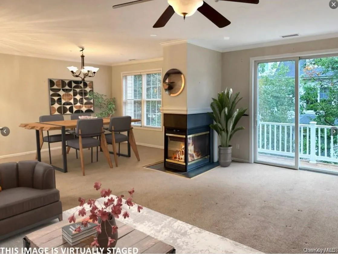Virtually staged image of living room/dining room with gas fireplace and slider to private balcony overlooking the treetops Virtually staged image of living room/dining room with gas fireplace and slider to private balcony overlooking the treetops