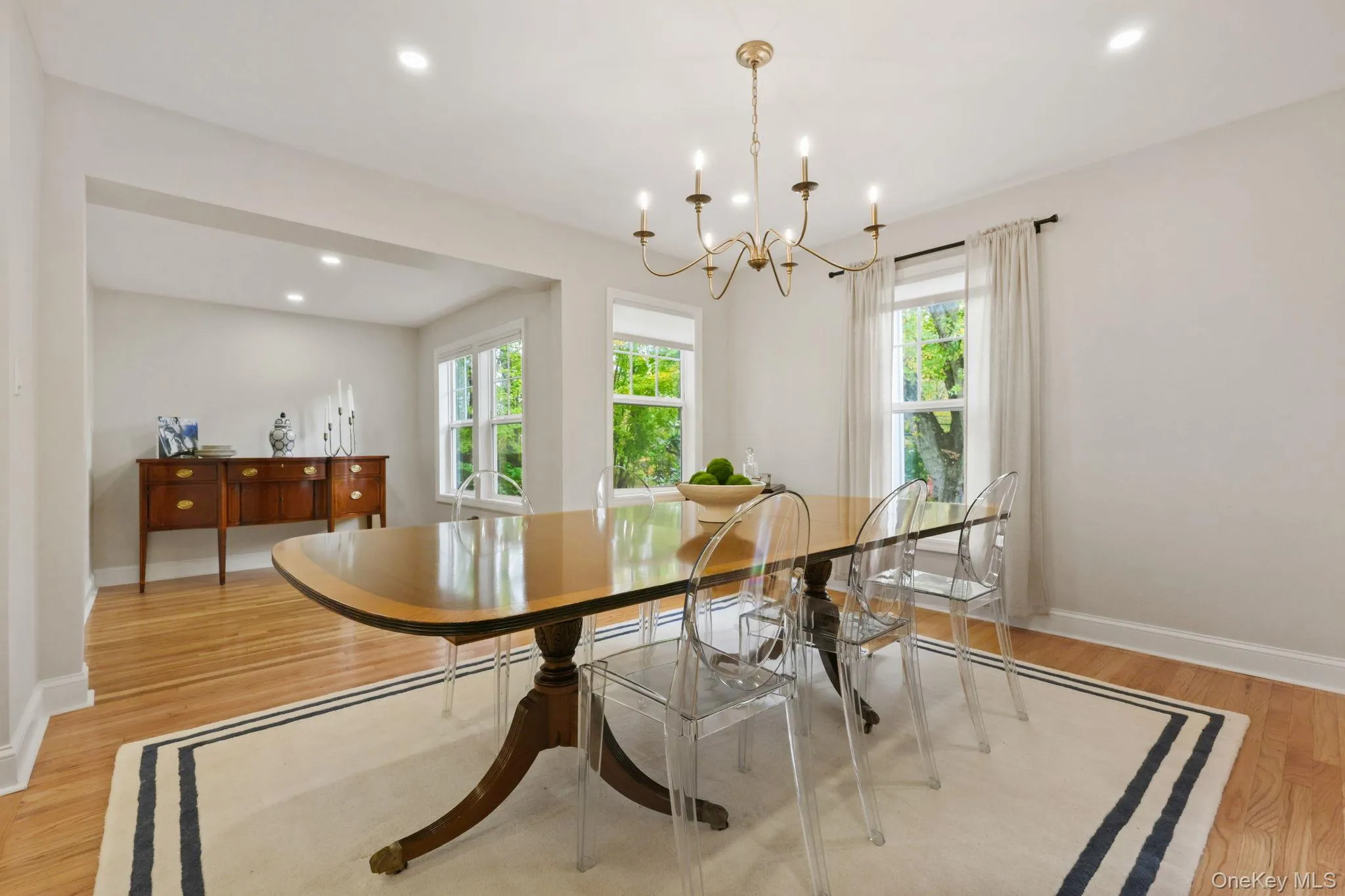 Dining area featuring light wood-type flooring, recessed lighting, and a chandelier Dining area featuring light wood-type flooring, recessed lighting, and a chandelier