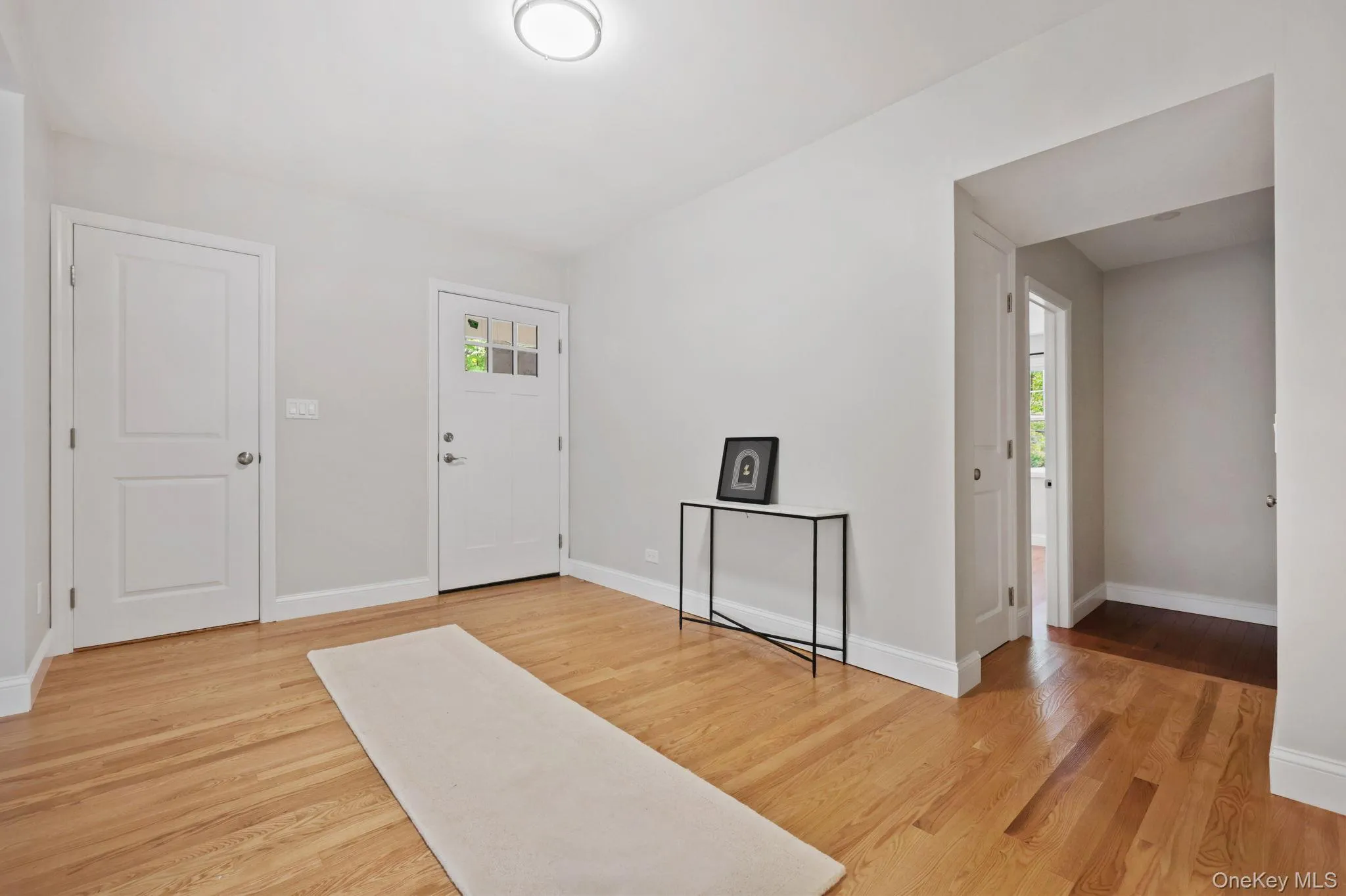 Entryway featuring light wood-type flooring and baseboards Entryway featuring light wood-type flooring and baseboards