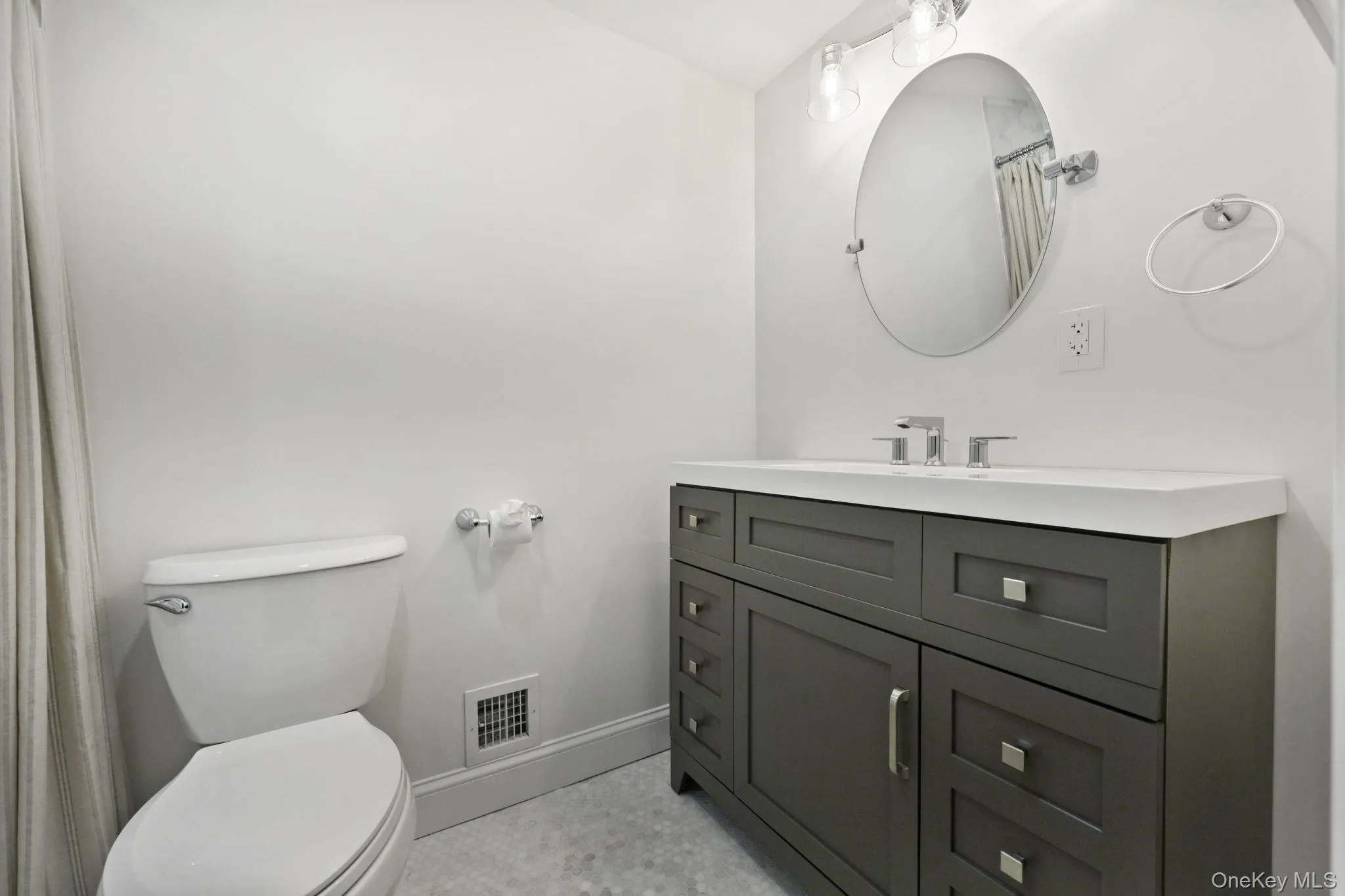 Bathroom with vanity and a shower with shower curtain Bathroom with vanity and a shower with shower curtain