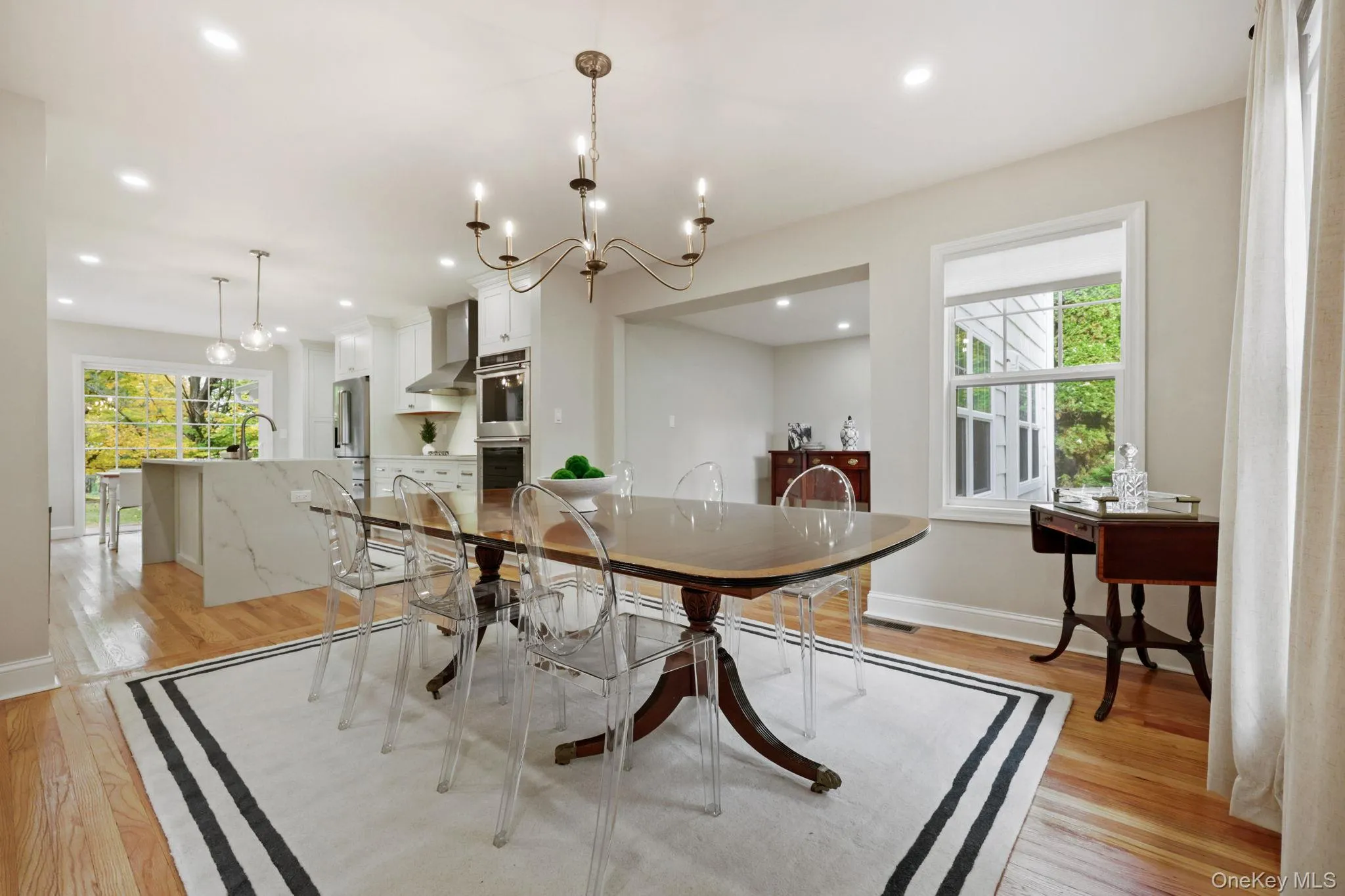 Dining room with a chandelier, light wood finished floors, and recessed lighting Dining room with a chandelier, light wood finished floors, and recessed lighting