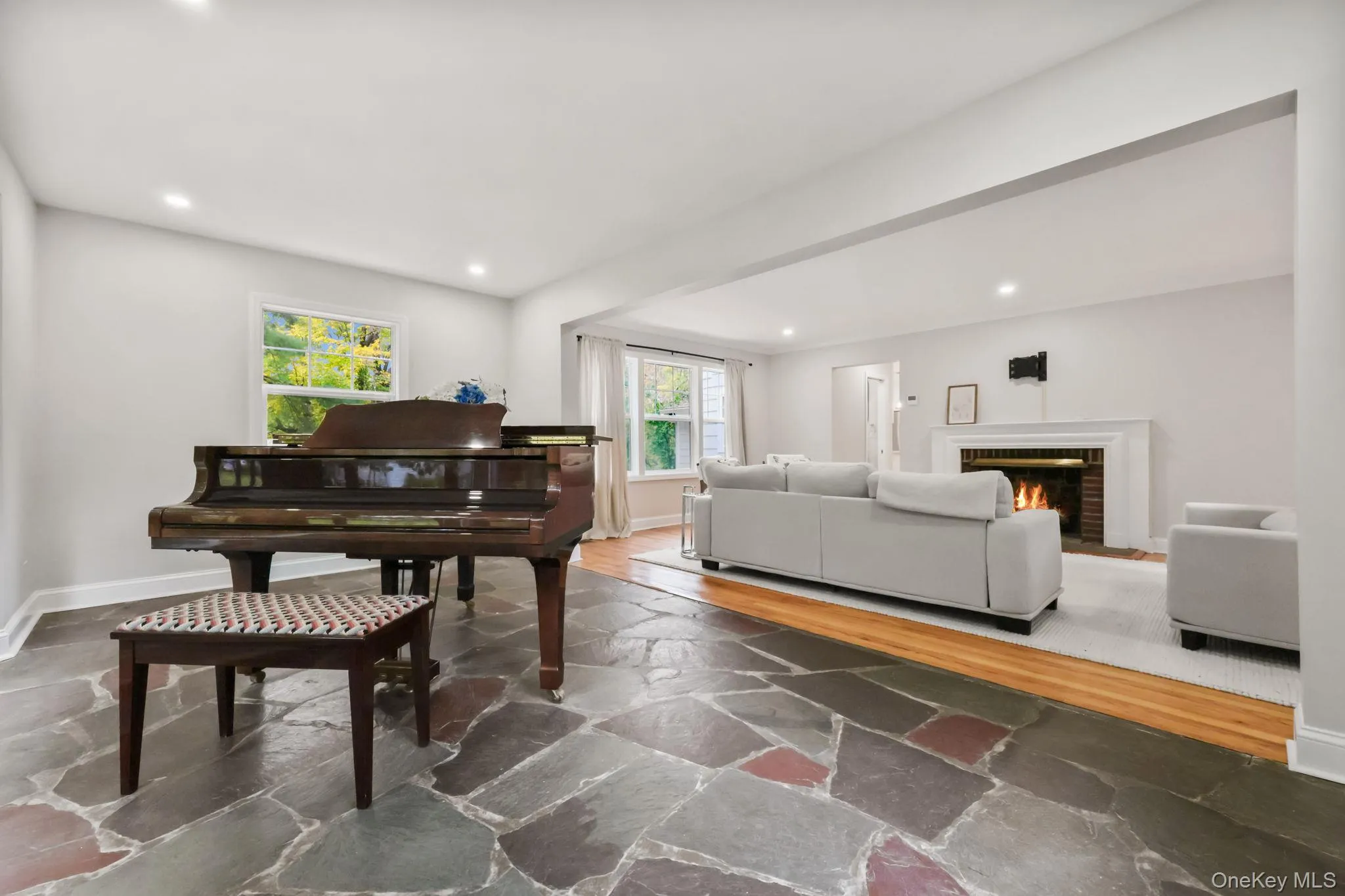 Living area with stone tile flooring, a fireplace, and recessed lighting Living area with stone tile flooring, a fireplace, and recessed lighting