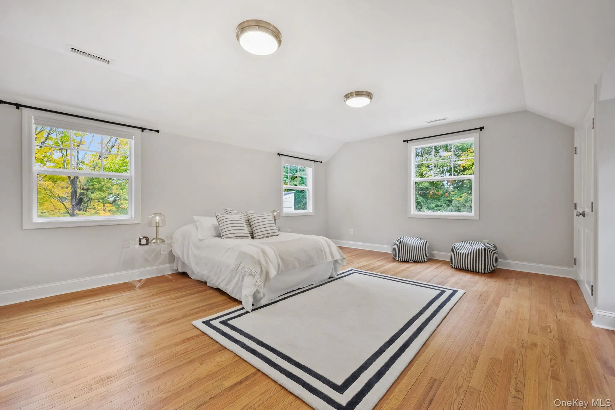 Bedroom with lofted ceiling and light wood-type flooring Bedroom with lofted ceiling and light wood-type flooring