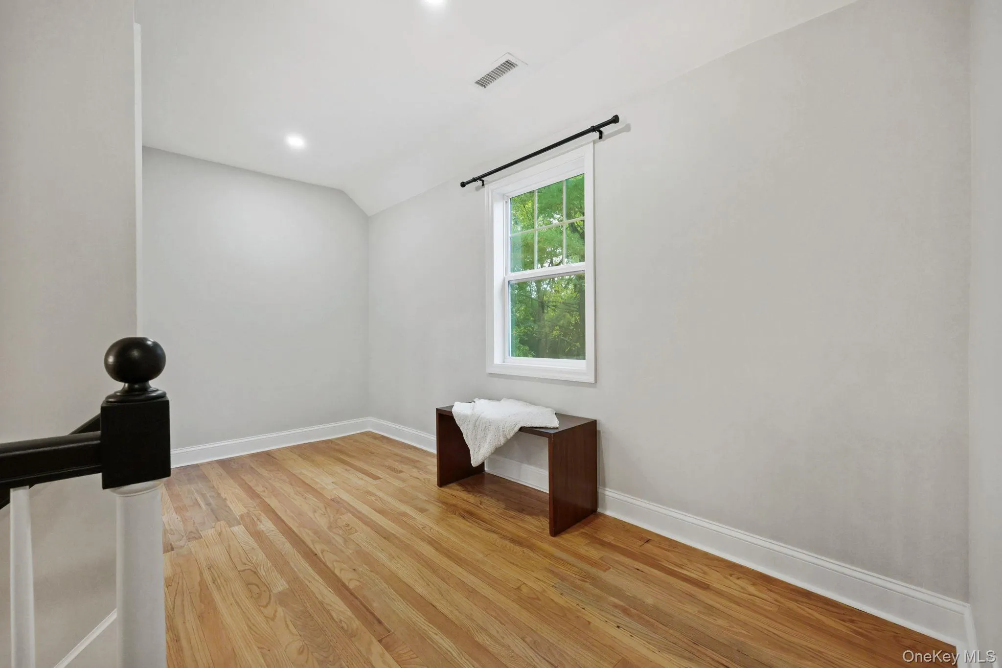 Spare room with light wood-style floors, lofted ceiling, and recessed lighting Spare room with light wood-style floors, lofted ceiling, and recessed lighting