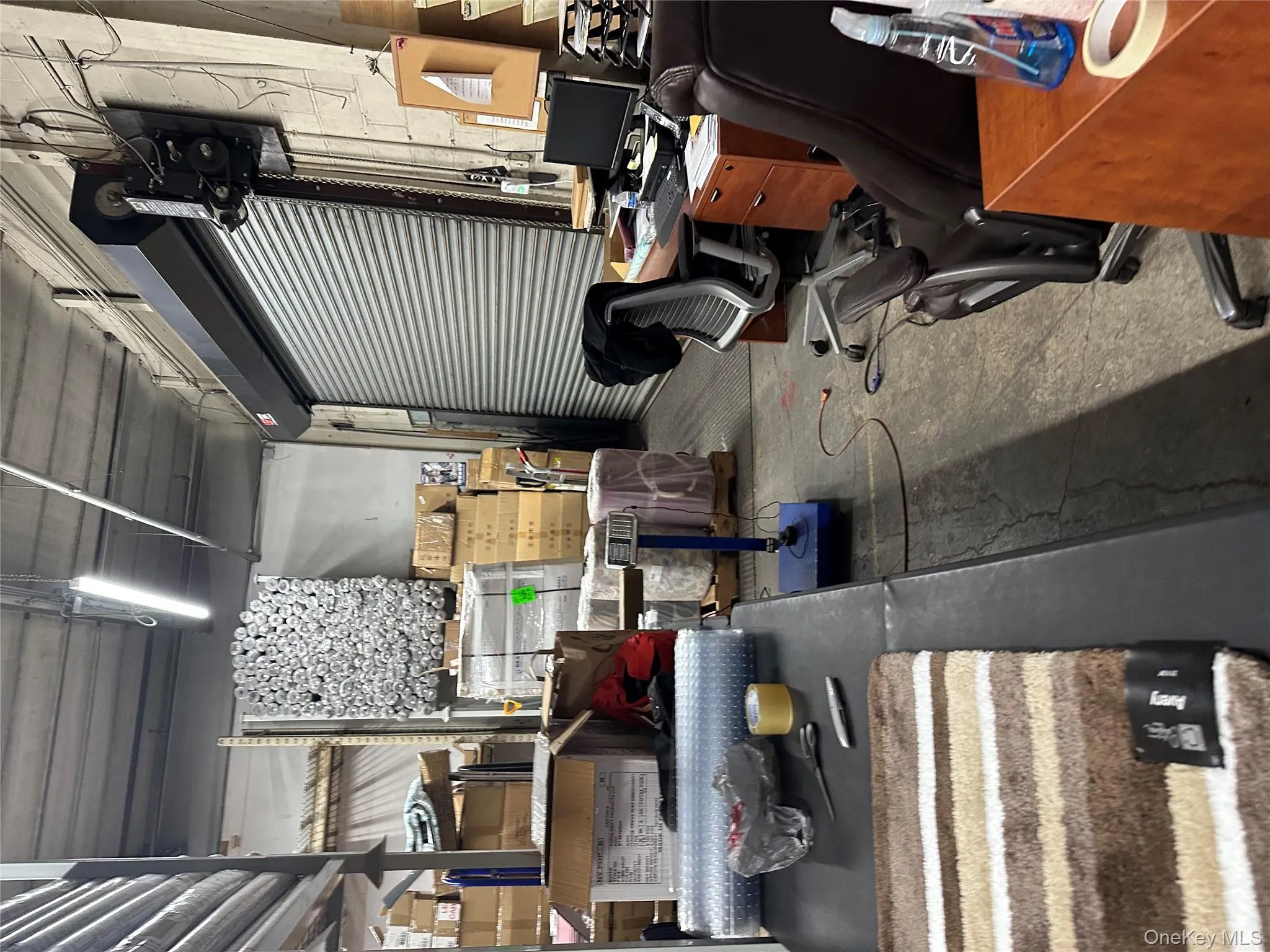 Office with unfinished concrete floors and a workshop area Office with unfinished concrete floors and a workshop area