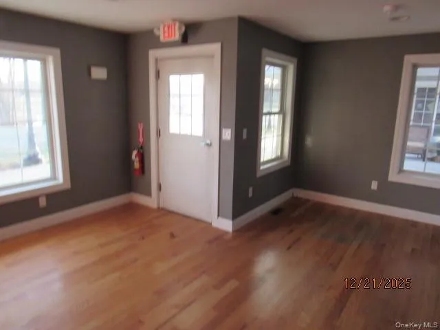 Entrance foyer featuring healthy amount of natural light and wood finished floors Entrance foyer featuring healthy amount of natural light and wood finished floors