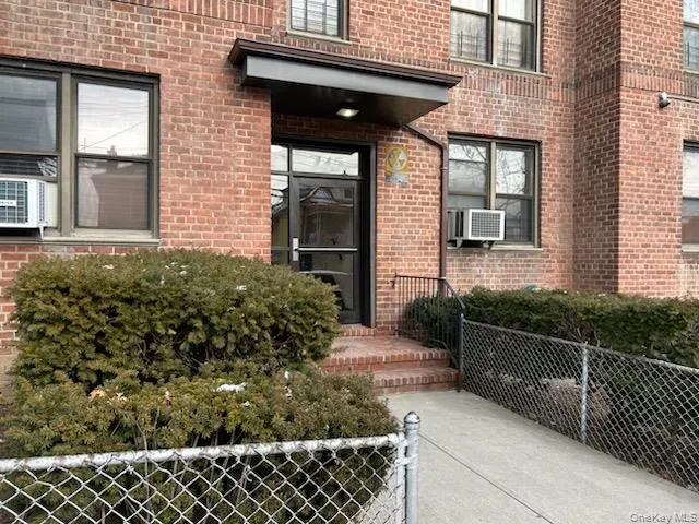 Doorway to property featuring brick siding Doorway to property featuring brick siding