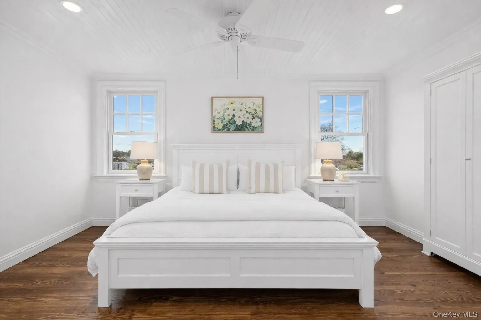 Bedroom featuring dark wood-style floors, a ceiling fan, multiple windows, crown molding, and wood ceiling Bedroom featuring dark wood-style floors, a ceiling fan, multiple windows, crown molding, and wood ceiling