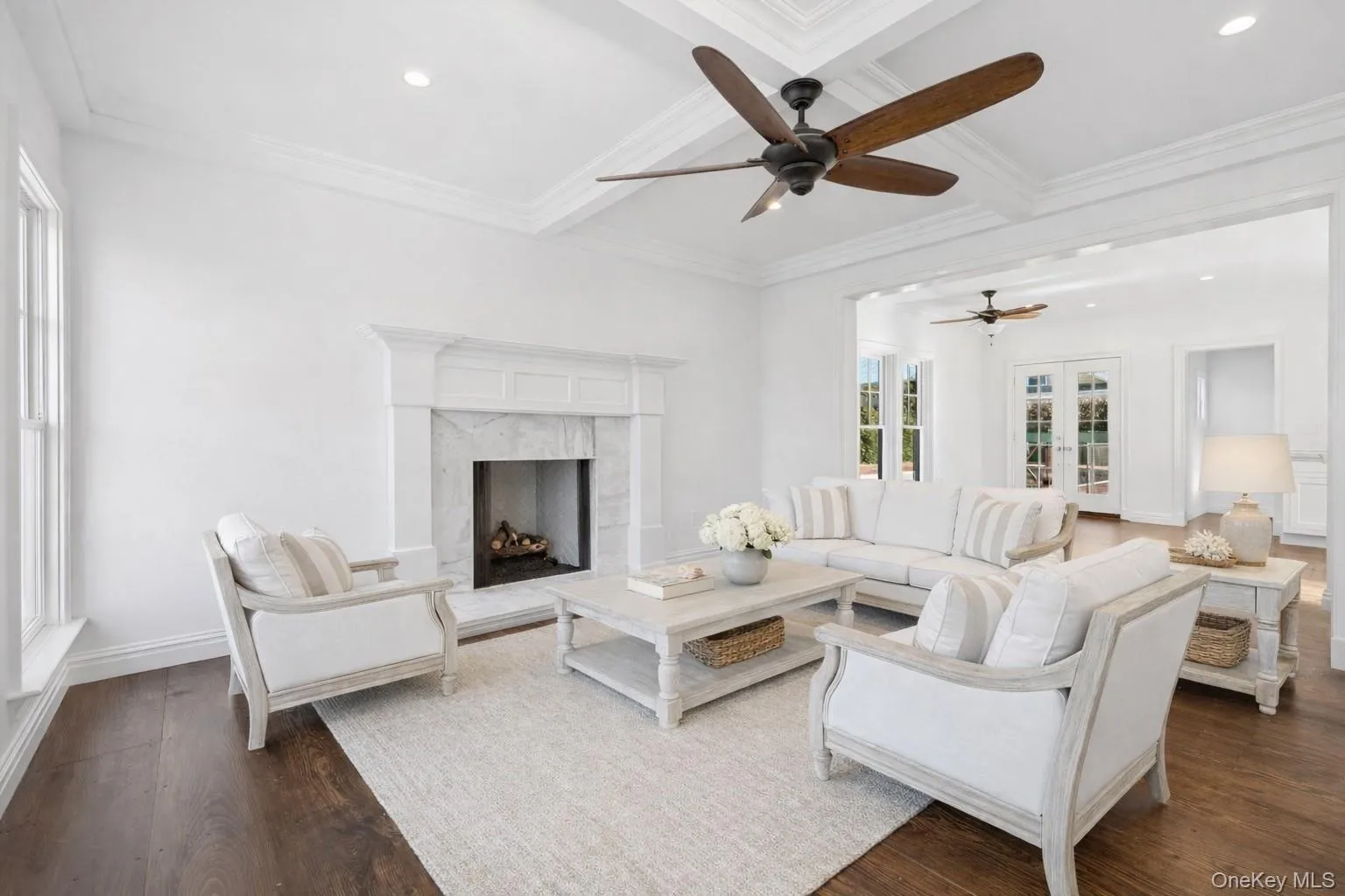 Living area with beamed ceiling, coffered ceiling, a high end fireplace, recessed lighting, and dark wood-type flooring Living area with beamed ceiling, coffered ceiling, a high end fireplace, recessed lighting, and dark wood-type flooring