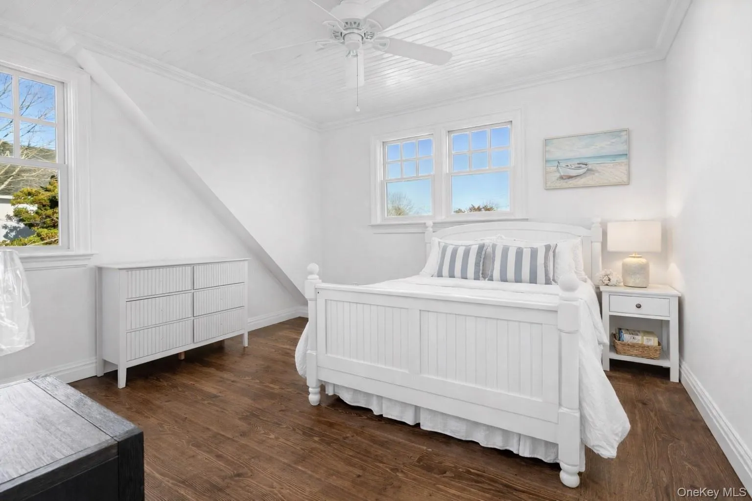 Bedroom featuring ceiling fan, dark wood-style flooring, wooden ceiling, multiple windows, and ornamental molding Bedroom featuring ceiling fan, dark wood-style flooring, wooden ceiling, multiple windows, and ornamental molding