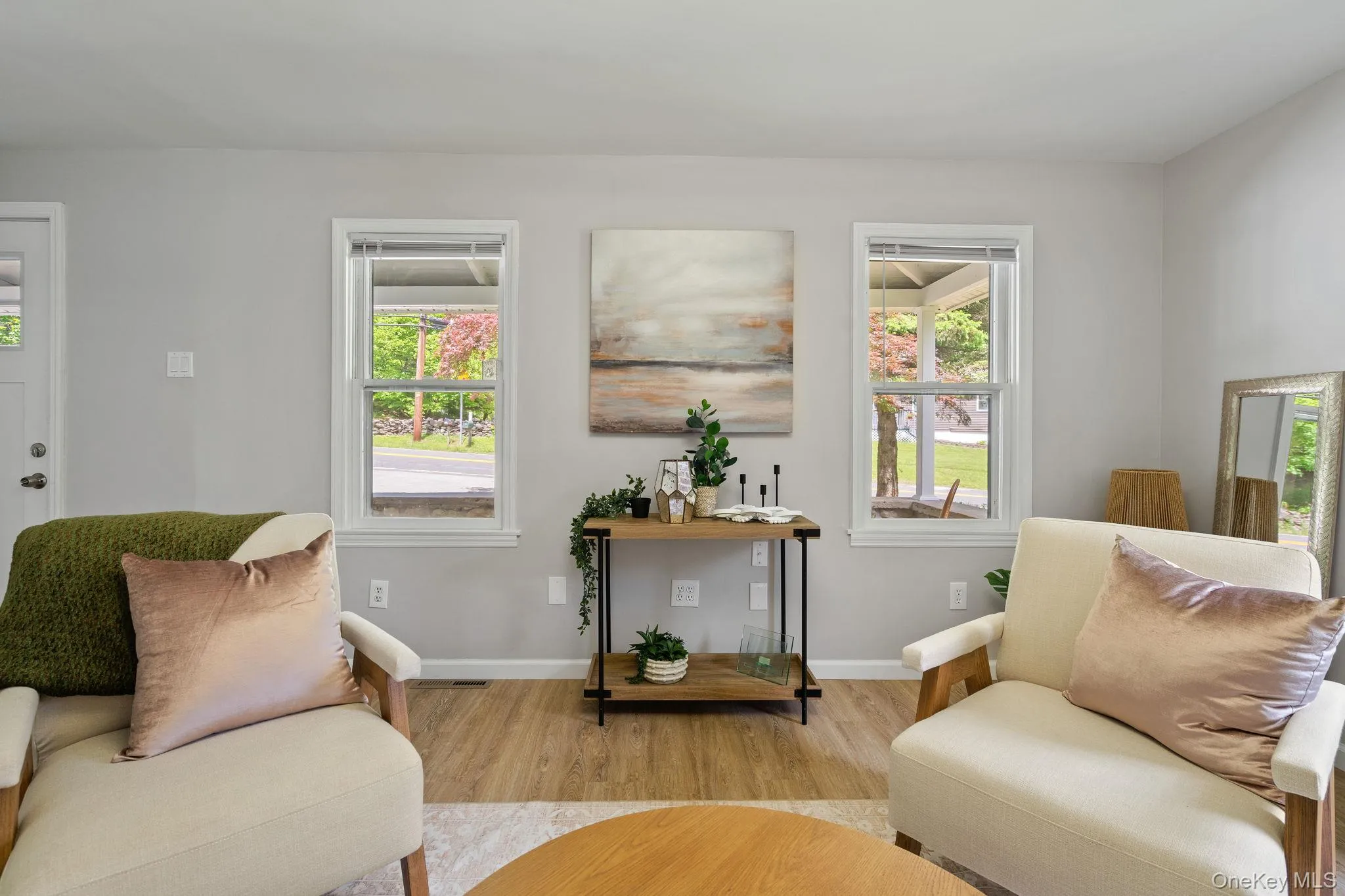 Living area with plenty of natural light and wood finished floors Living area with plenty of natural light and wood finished floors