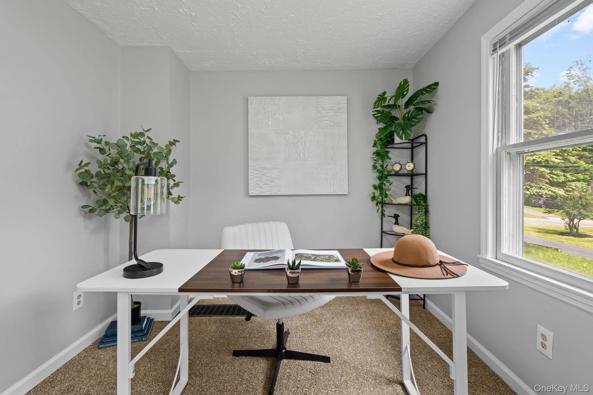 Home office featuring carpet and a textured ceiling Home office featuring carpet and a textured ceiling