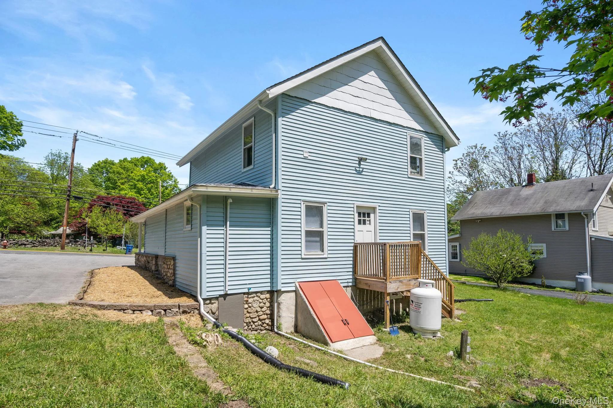 Back of house featuring a yard Back of house featuring a yard