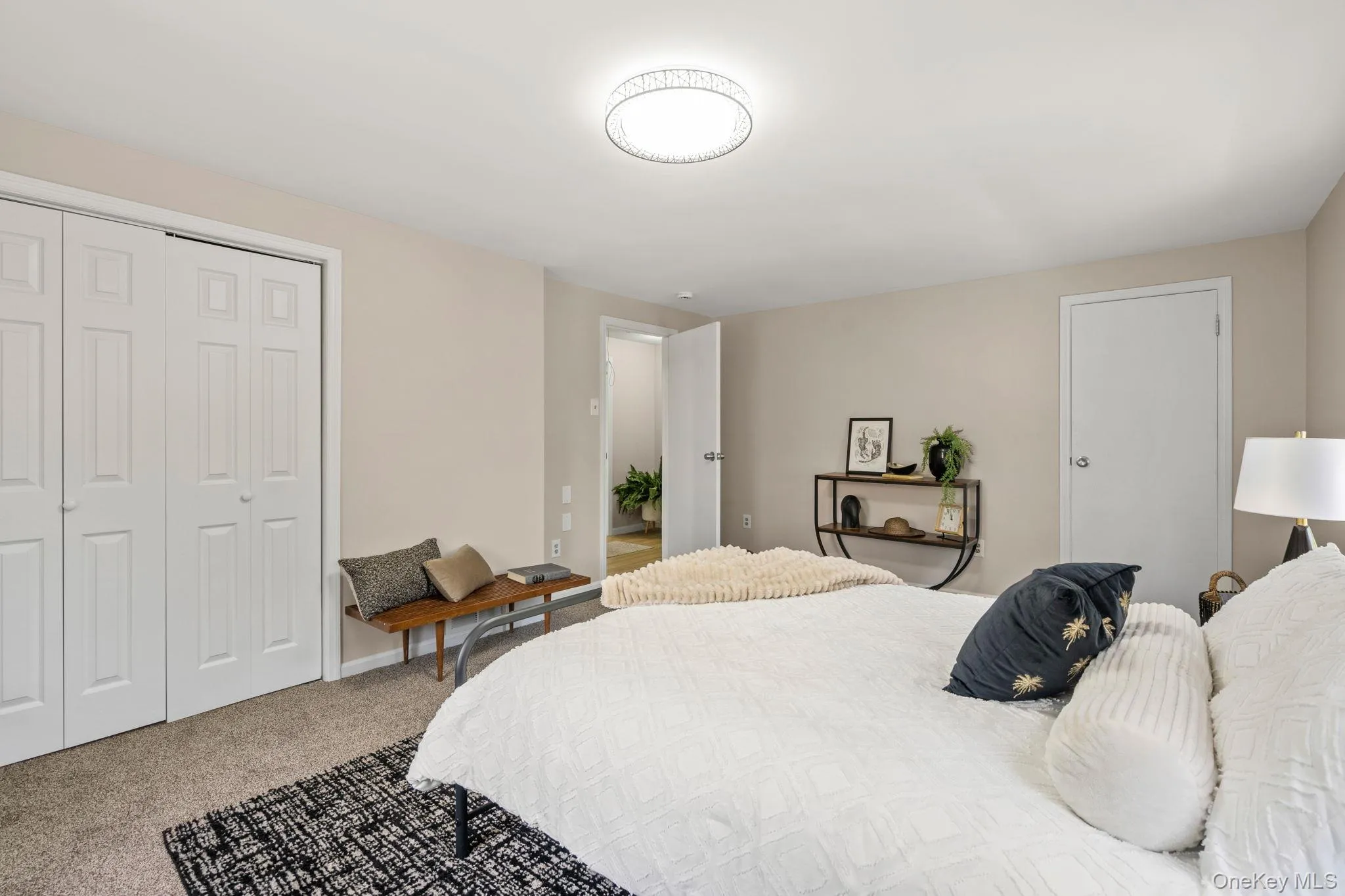 Bedroom featuring carpet flooring and a closet Bedroom featuring carpet flooring and a closet