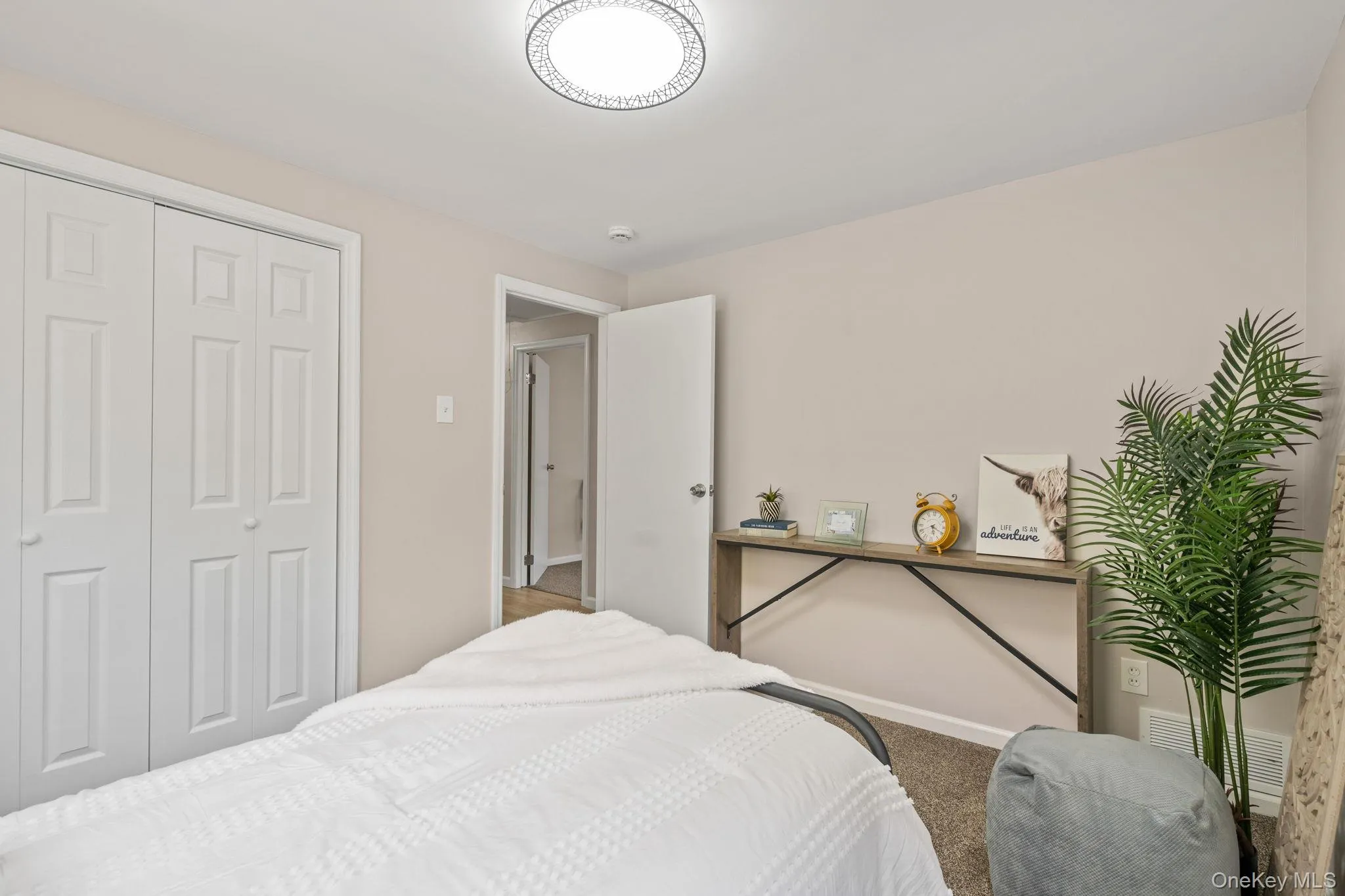 Bedroom with a closet and carpet floors Bedroom with a closet and carpet floors