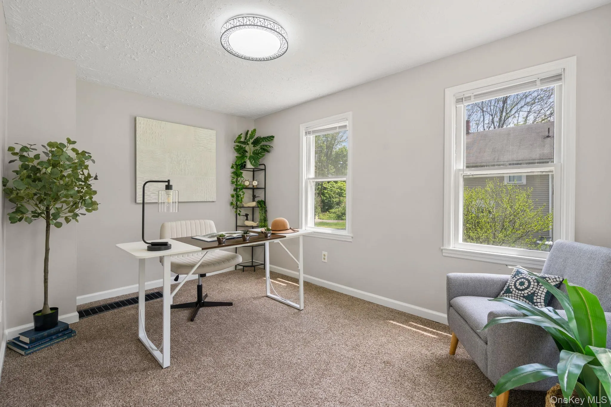 Office with carpet floors and a textured ceiling Office with carpet floors and a textured ceiling
