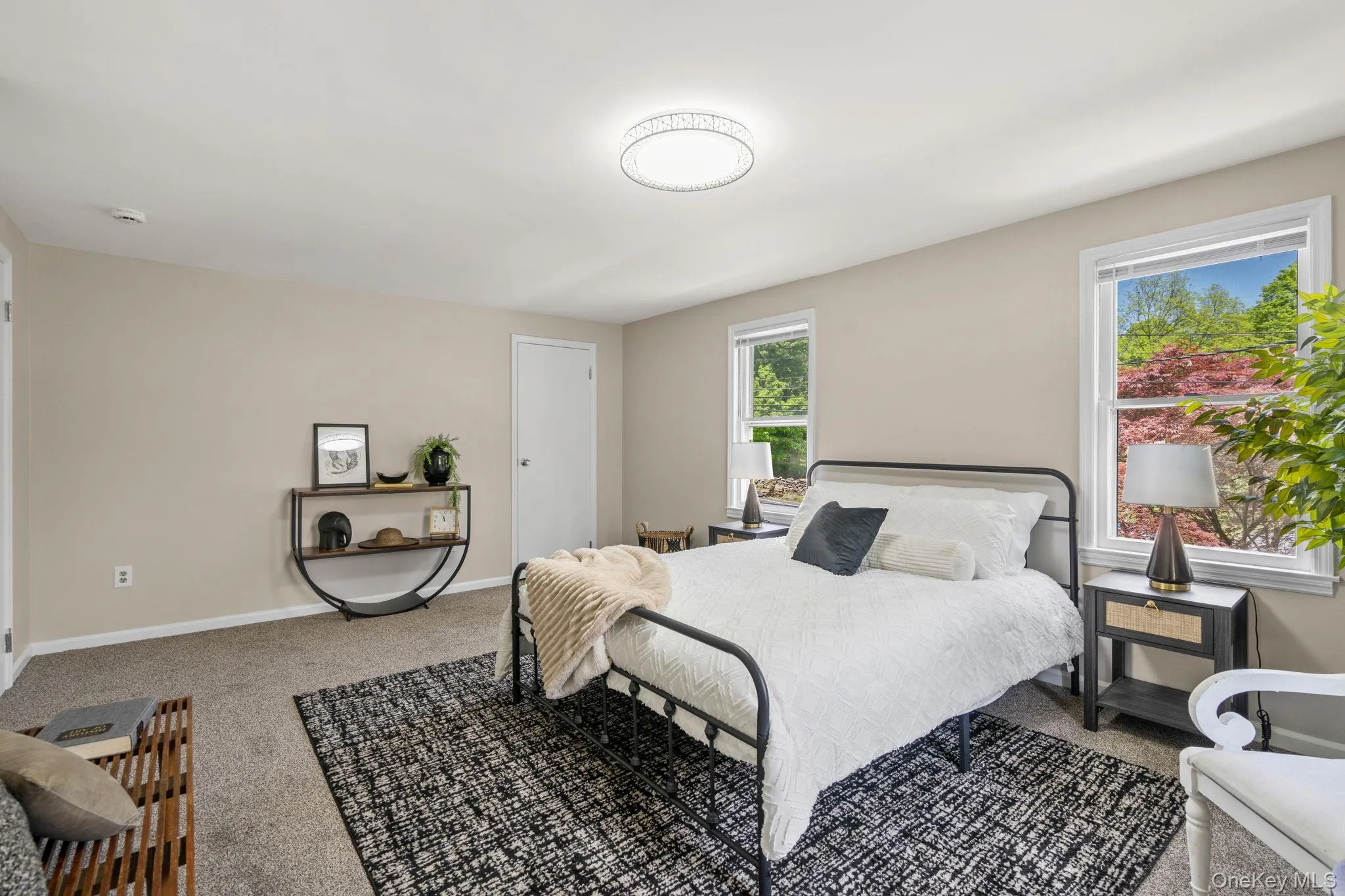 Bedroom featuring baseboards and carpet flooring Bedroom featuring baseboards and carpet flooring