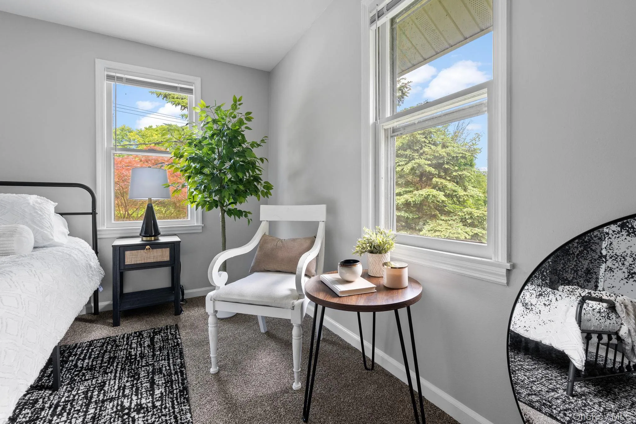 Bedroom featuring dark carpet and baseboards Bedroom featuring dark carpet and baseboards