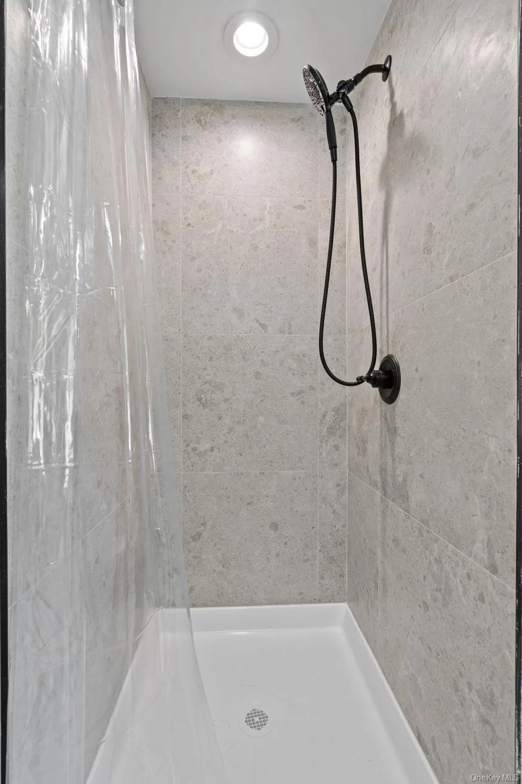 Full bathroom with a shower stall Full bathroom with a shower stall