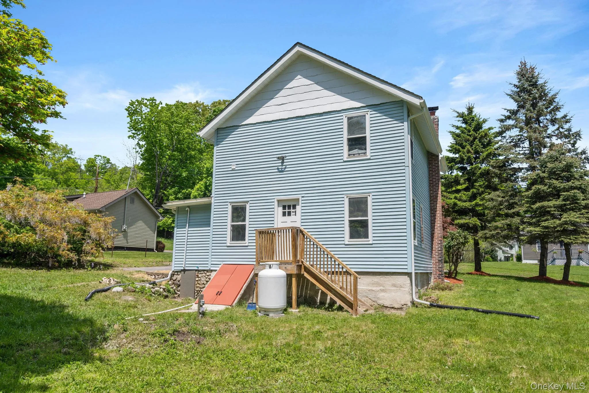 Rear view of property featuring a yard and a chimney Rear view of property featuring a yard and a chimney